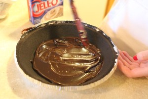 Pour and evenly spread 1/2 Cup of the hot fudge dessert, covering the bottom of the crust (we've found that putting the hot fudge in the microwave for about 20 seconds, make it easier to pour and spread!)