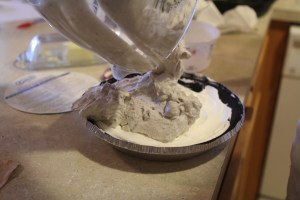 Spoon mixture over whipped topping layer in crust